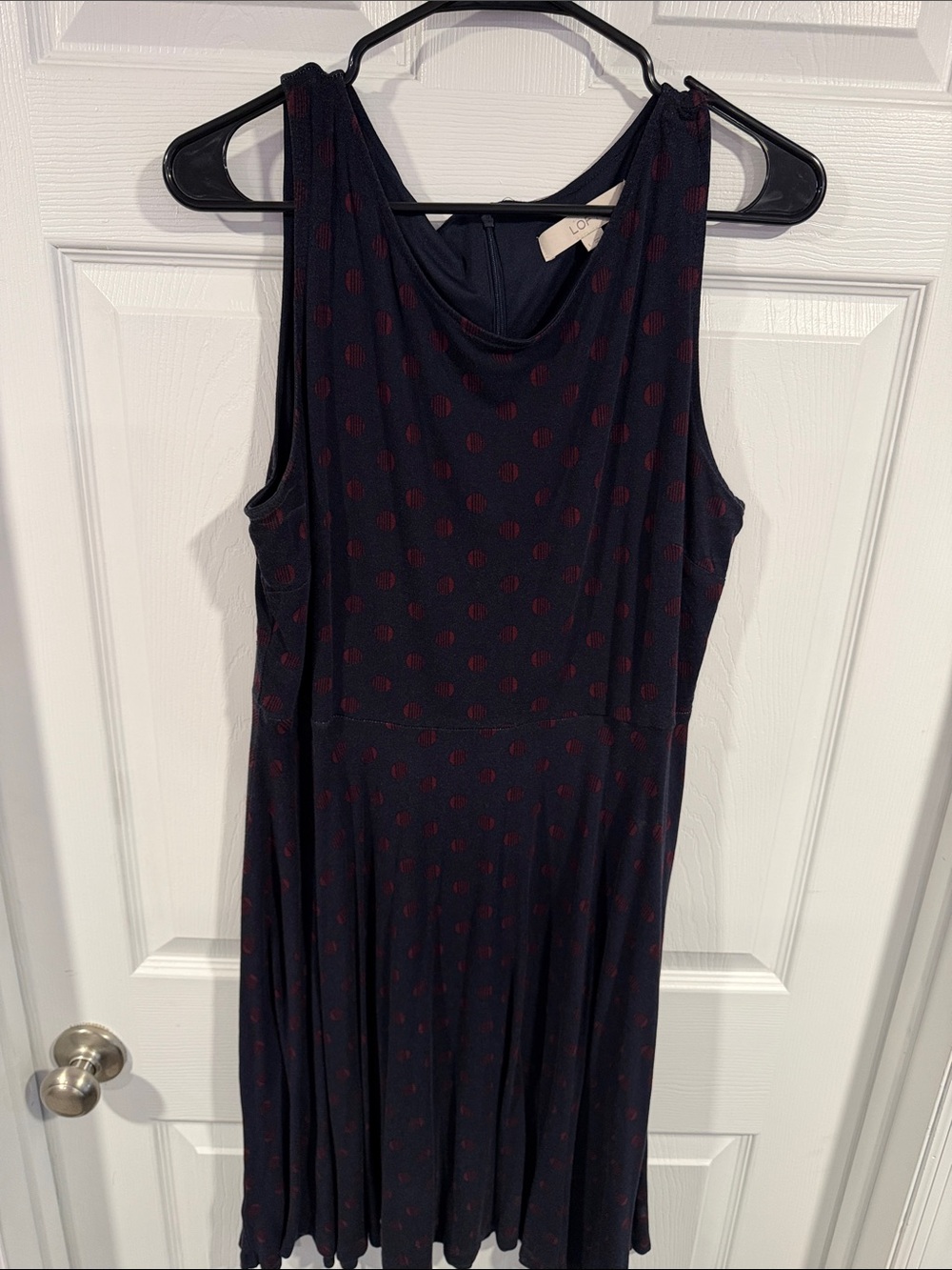 Black sleeveless dress with red dot pattern